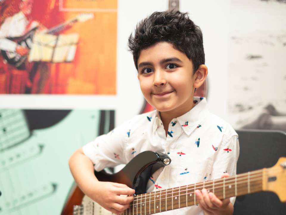 Bass Guitar Student in a Practice Room at the Cosmo School of Music